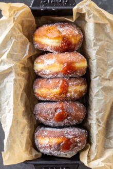 Jam filled brioche donuts in a pan.