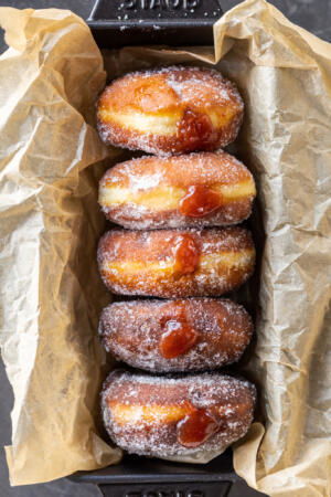 Jam filled brioche donuts in a pan.