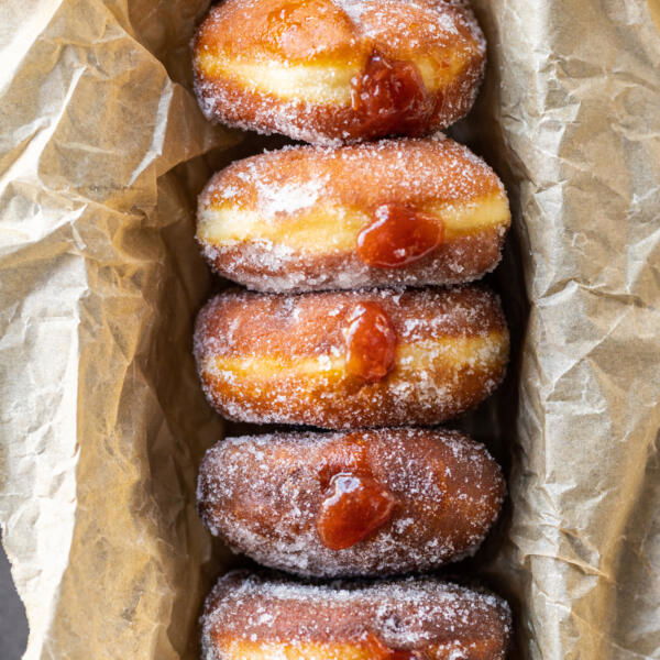 Jam filled brioche donuts in a pan.