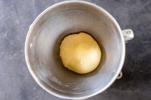 Brioche donut dough in a mixer bowl.