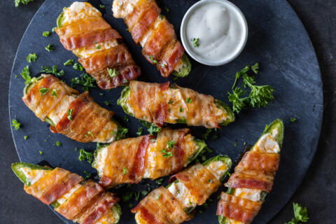 Sering tray Bacon Wrapped Jalapeño Poppers.