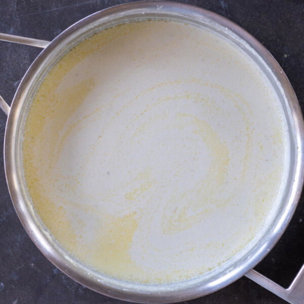 Alfredo sauce in a pan.