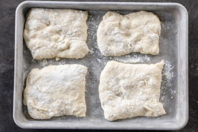 Dough cut into pieces on a baking sheet.