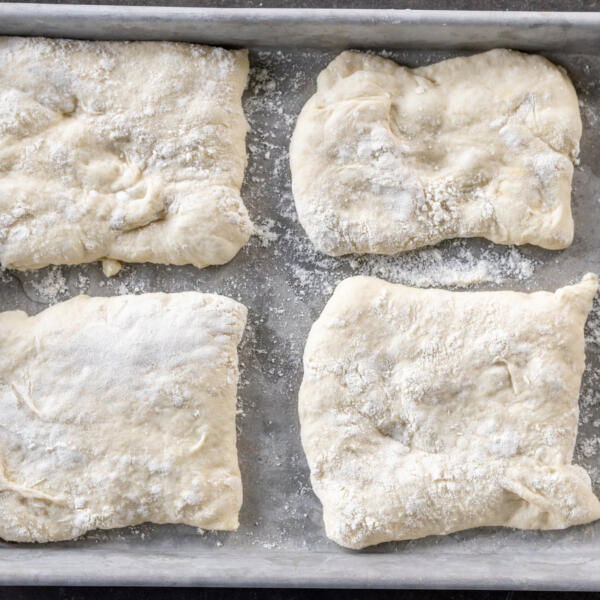 Dough cut into pieces on a baking sheet.