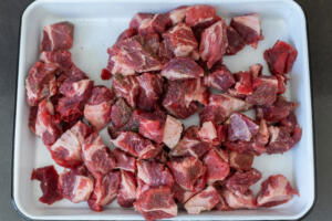 Seasoned beef on a tray.