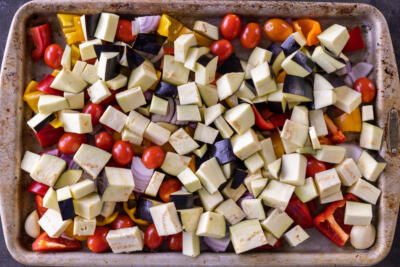 Veggies chopped up on a baking sheet.