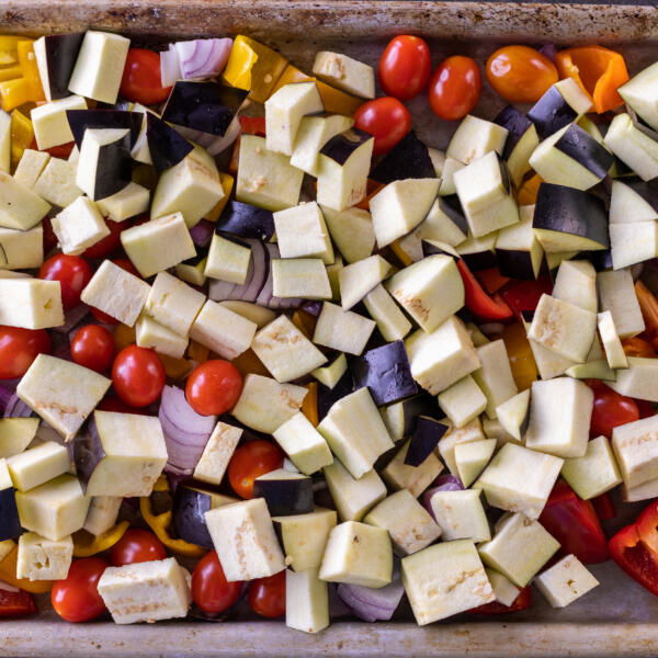 Veggies chopped up on a baking sheet.