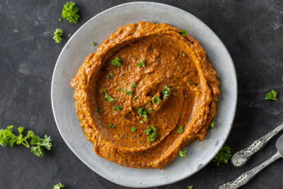 Eggplant Pepper Dip topped with herbs.