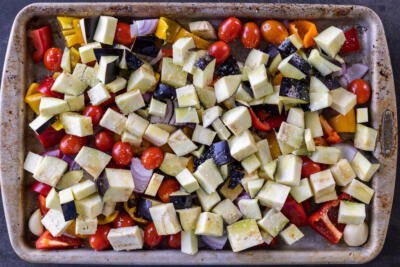 Seasoned veggies on a baking sheet.