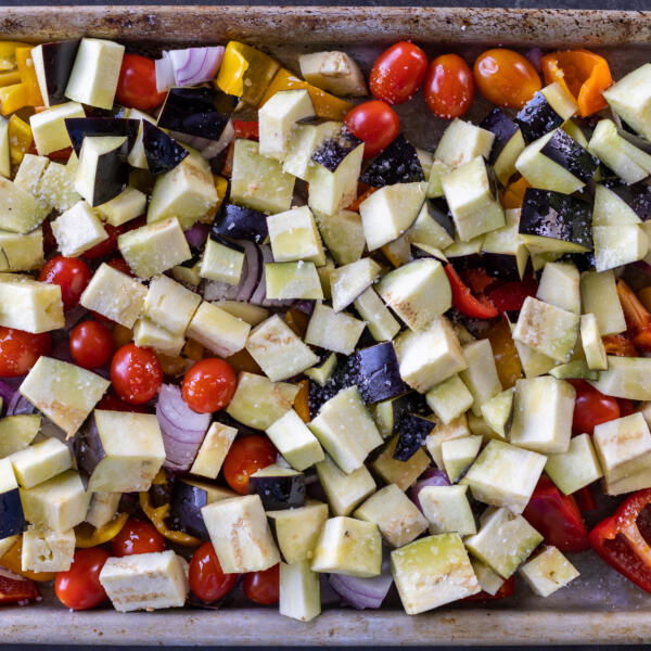 Seasoned veggies on a baking sheet.