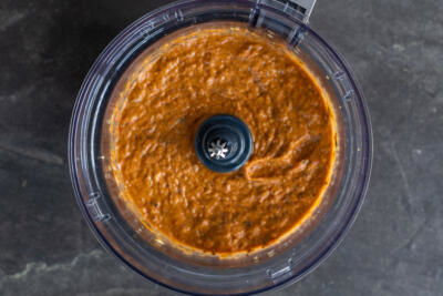 Blended eggplant pepper dip in a food processor.