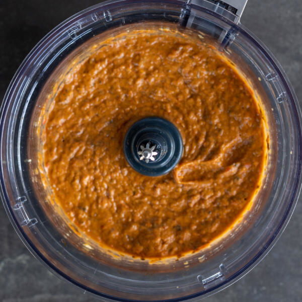 Blended eggplant pepper dip in a food processor.