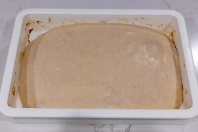 High Hydration Sourdough Bread dough in a pan.