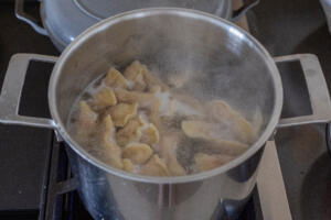 Vareniki boiling in a pot.