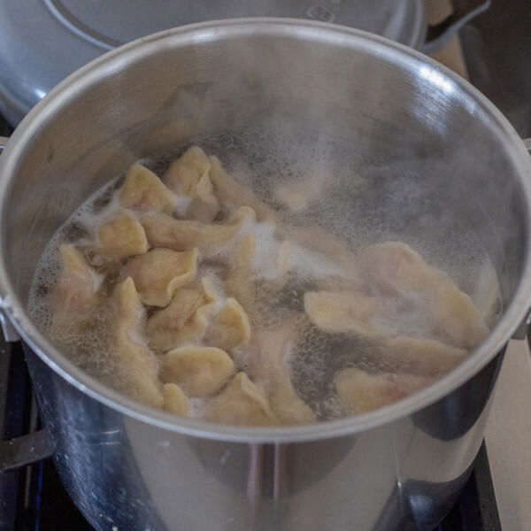 Vareniki boiling in a pot.