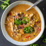 A bowl with Creamy Chicken Taco Soup and toppings.