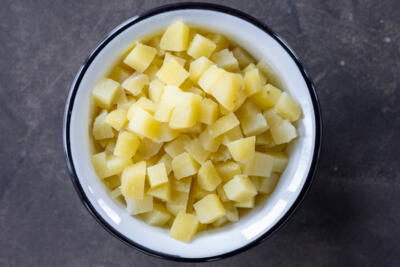 Cooked potatoes cut into pieces.