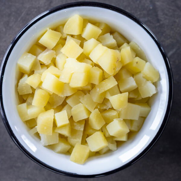 Cooked potatoes cut into pieces.
