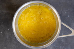Eggs and sugar in a pot.