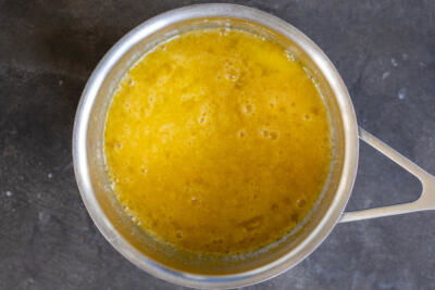 Eggs and sugar in a pot.