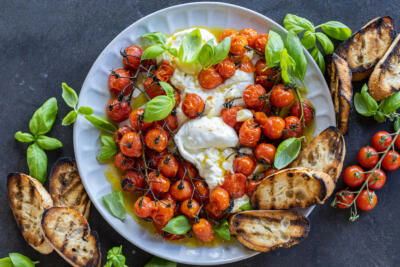 Basil with Braised Tomatoes with Burrata and bread on the side.
