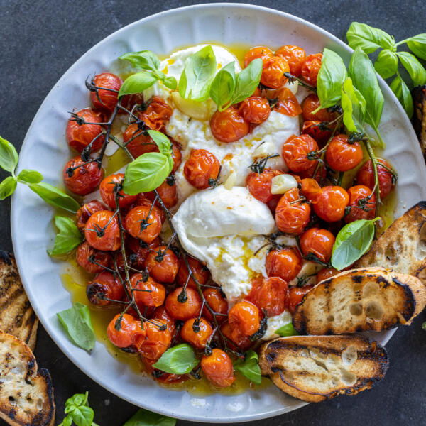 Basil with Braised Tomatoes with Burrata and bread on the side.