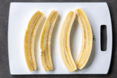 Sliced up bananas into half lengthwise.