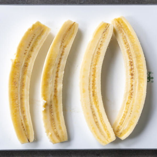 Sliced up bananas into half lengthwise.