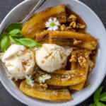 Classic Bananas Foster in a serving plate with ice cream.