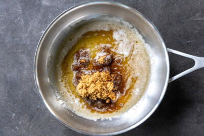 Butter, sugar, vanilla and rum in a pan.