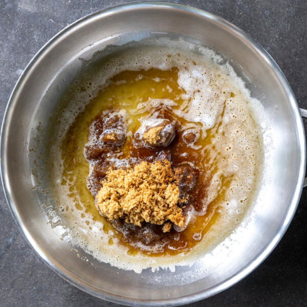 Butter, sugar, vanilla and rum in a pan.
