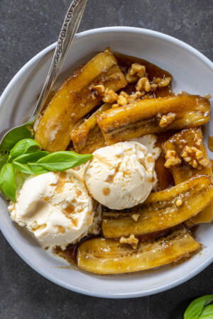 Classic Bananas Foster in a bowl with ice cream.