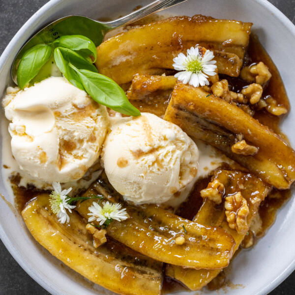 Classic Bananas Foster in a bowl with ice cream.
