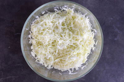 Sliced up cabbage in a bowl.