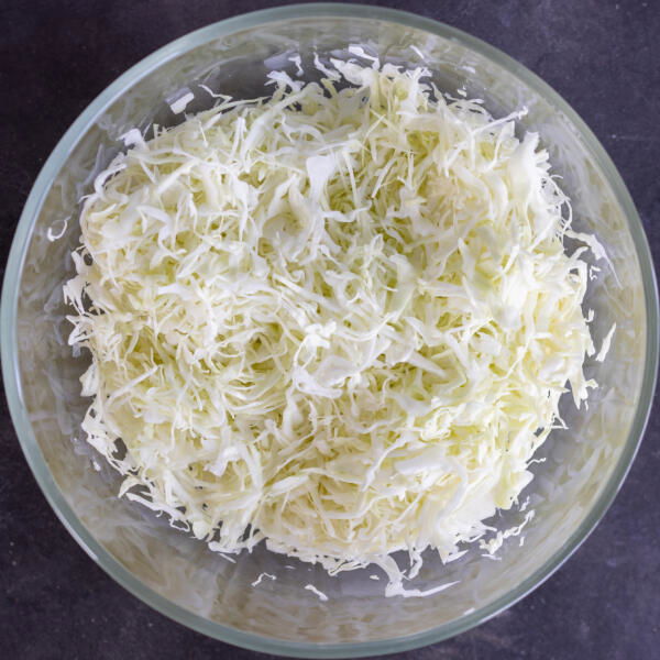 Sliced up cabbage in a bowl.