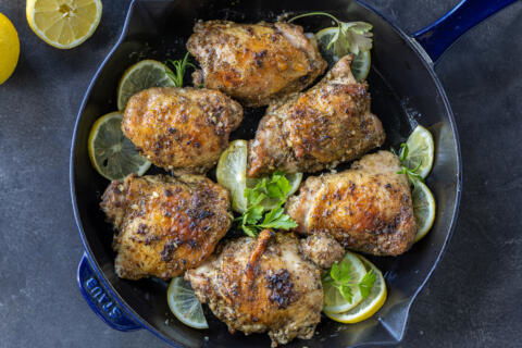 Greek Lemon Chicken plated with lemon and herbs.