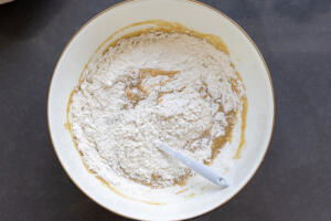 Dry ingredients added to the bowl with all the liquids.