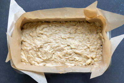 Banana bread batter in a loaf pan.