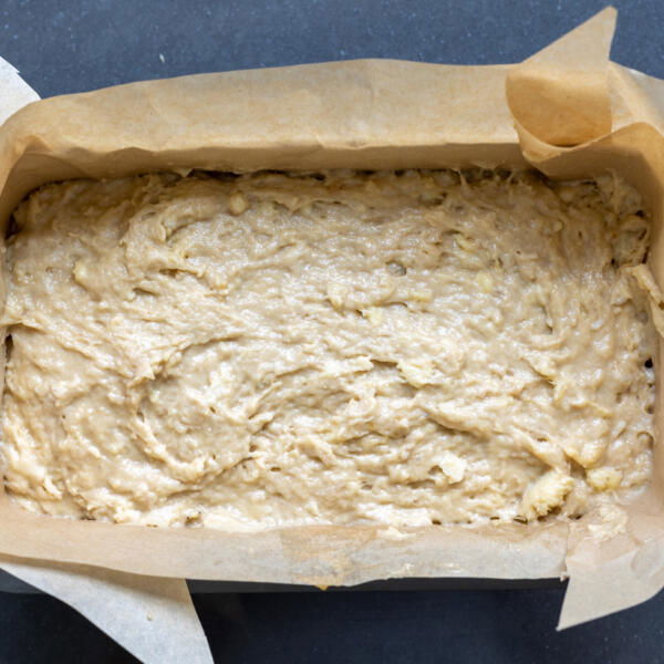 Banana bread batter in a loaf pan.