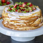 Strawberry Crepe Cake on a cake stand.