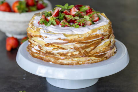 Strawberry Crepe Cake on a cake stand.