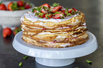 Strawberry Crepe Cake on a cake stand.