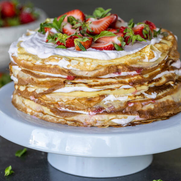 Strawberry Crepe Cake on a cake stand.