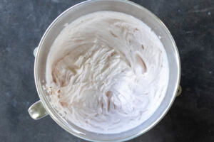 Strawberry crepe cake cream in a mixing bowl.