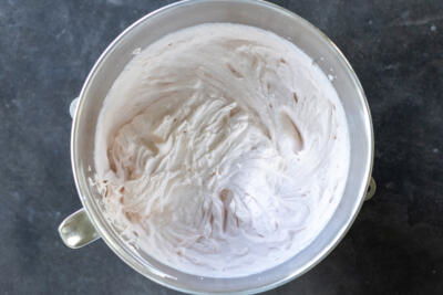 Strawberry crepe cake cream in a mixing bowl.