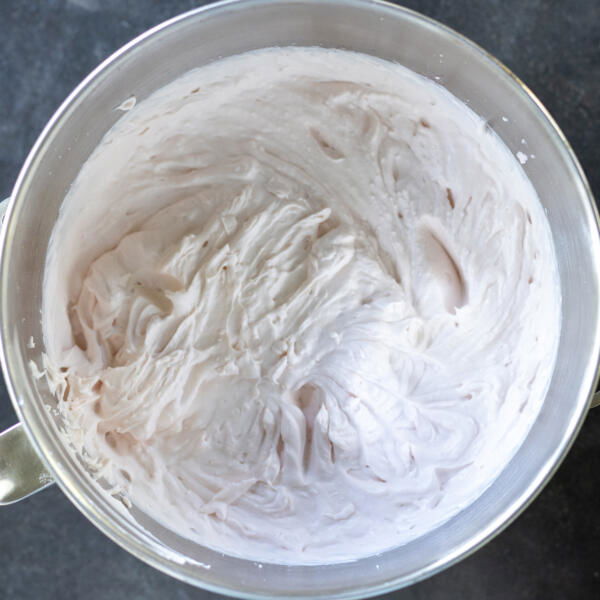 Strawberry crepe cake cream in a mixing bowl.