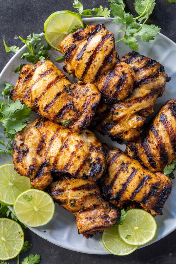 Cilantro Lime Chicken on a plate with lime and cilantro. 