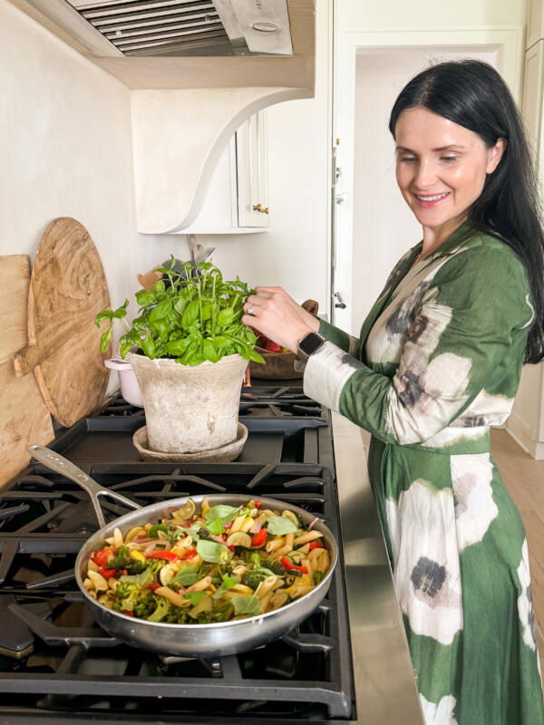 Natalya in a shot with Pasta Primavera in a pan.