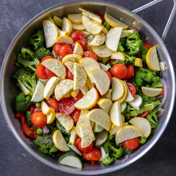 A pan with a lot of veggies cooking.