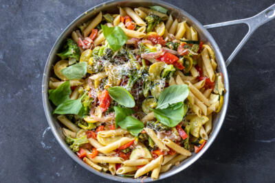Cheese and basil added to pasta with veggies.